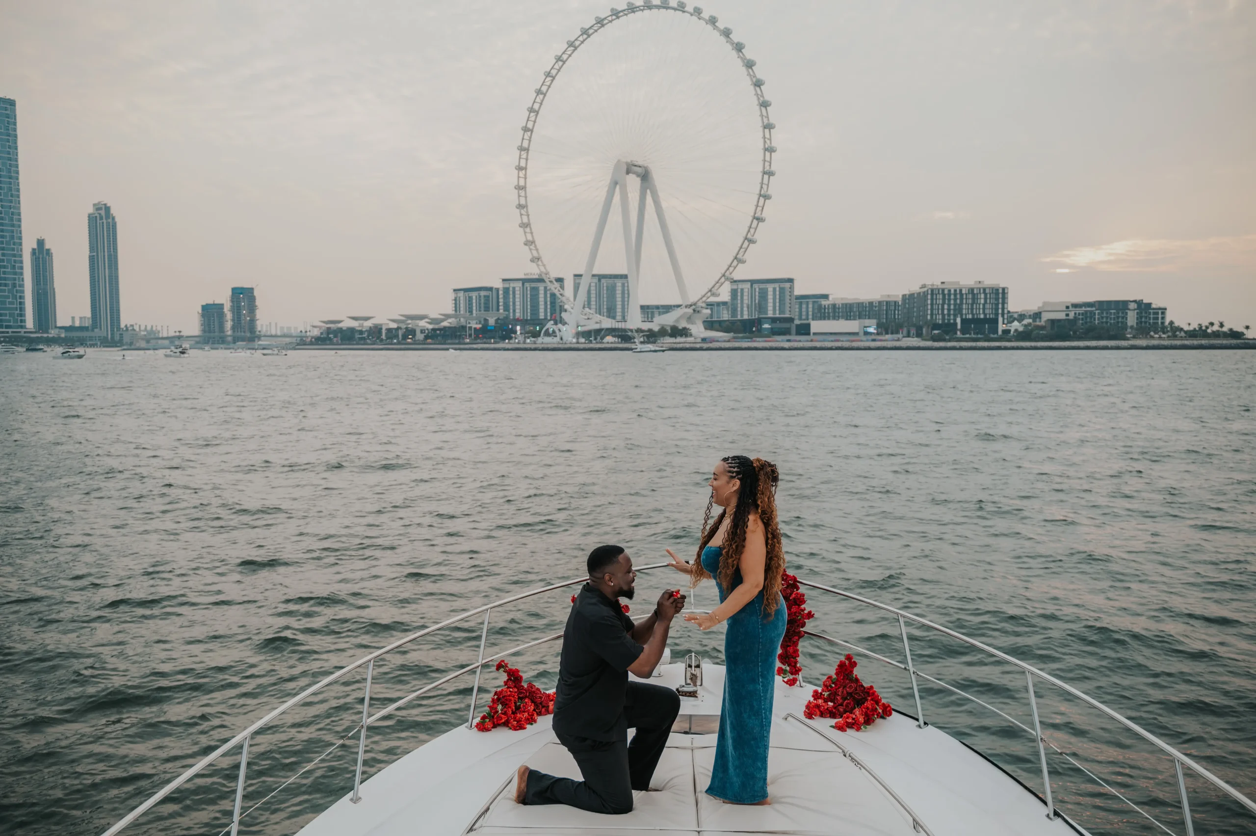 Guy on his knees during his proposal in Dubai captured by a professional photographer